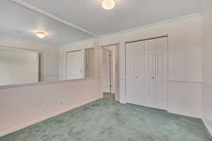 Extra bedroom/den featuring carpet flooring and ornamental molding