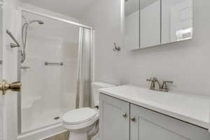 Master bathroom featuring vanity, a shower stall, and LVP finished floors