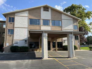 View of property with uncovered parking