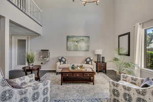 Living area with a high ceiling and wood finished floors, level 1 lobby