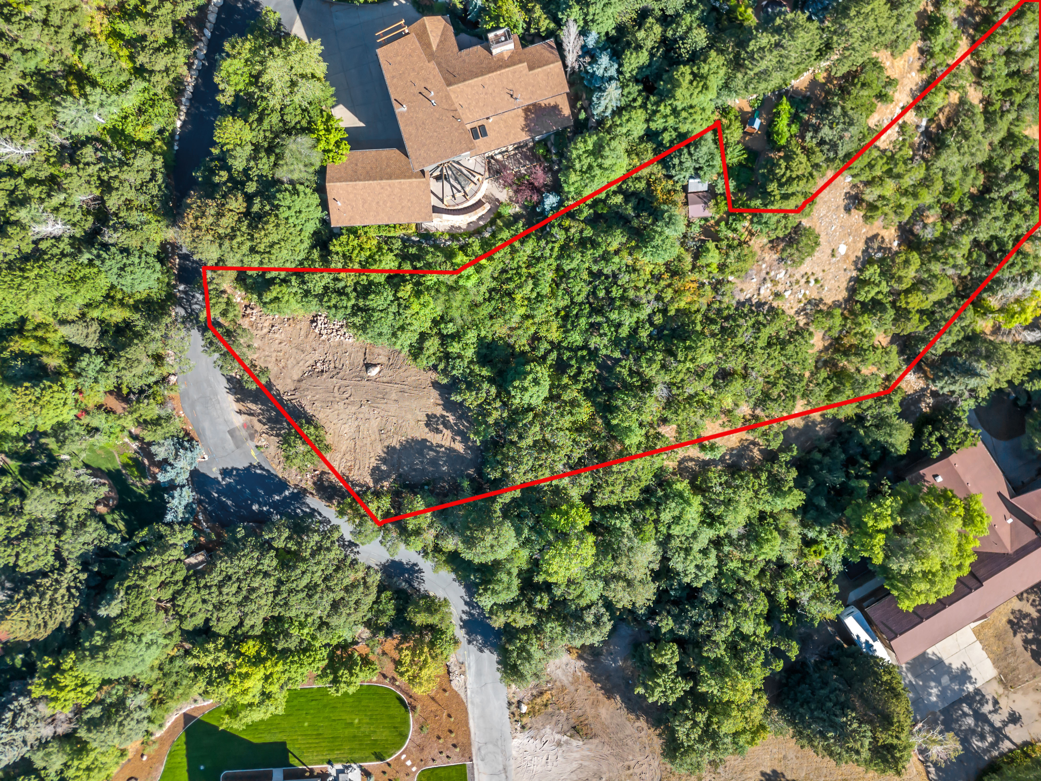 Aerial view of property and surrounding area with property boundaries highlighted