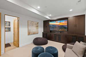Carpeted cinema with baseboards and recessed lighting