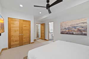 Carpeted bedroom with recessed lighting, a ceiling fan, and ensuite bathroom