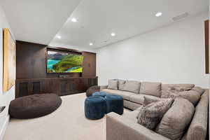 Home theater room with carpet floors and recessed lighting