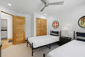 Bedroom with light colored carpet, recessed lighting, a ceiling fan, and a closet