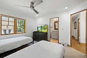 Bedroom featuring light colored carpet, recessed lighting, ensuite bathroom, and ceiling fan
