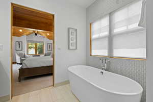 Full bathroom with ensuite bath, a freestanding bath, wooden ceiling, and lofted ceiling