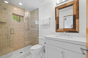 Bathroom featuring a stall shower and vanity