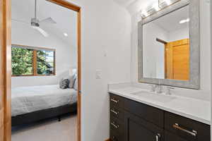 Bathroom with vanity, recessed lighting, ensuite bathroom, lofted ceiling, and ceiling fan