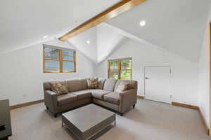 Living room with light colored carpet and recessed lighting