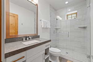 Full bathroom with vanity and a stall shower