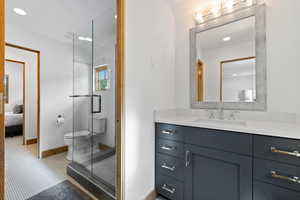 Full bathroom featuring recessed lighting, vanity, a stall shower, and connected bathroom