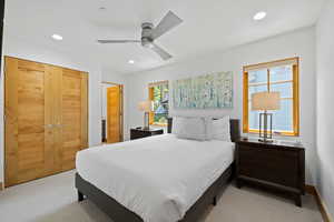 Bedroom featuring light colored carpet, recessed lighting, and a ceiling fan