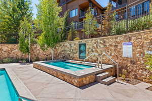 View of pool with a community hot tub