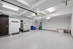 Garage with baseboards and a garage door opener