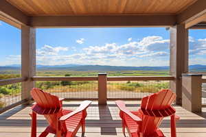 Deck with a mountain view and a view of countryside