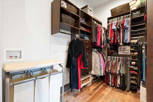 Spacious closet featuring wood finished floors