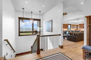 Staircase featuring hardwood / wood-style flooring and recessed lighting