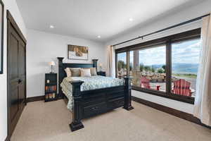 Bedroom with light carpet, recessed lighting, and a mountain view