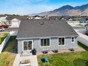 Back of house with roof with shingles, a residential view, and stucco siding