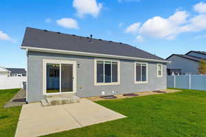 Rear view of house with a fenced backyard, a patio, stucco siding, and roof with shingles