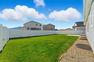 Fenced backyard featuring a residential view and a patio area