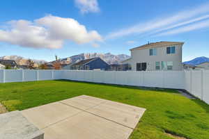 Fenced backyard with a mountain view and a patio area