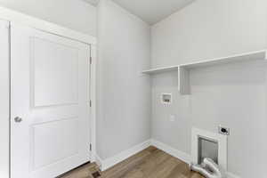 Laundry area featuring light wood-style floors, washer hookup, and electric dryer hookup