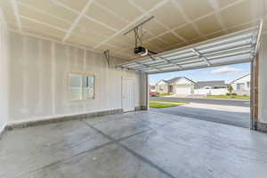 Garage featuring a residential view and a garage door opener