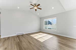 Empty room with vaulted ceiling, light wood-type flooring, ceiling fan, and recessed lighting