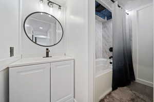 ADU Bathroom featuring vanity, shower / bath combo, and wood finished floors