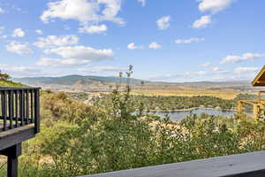 View of mountain backdrop featuring a nearby body of water