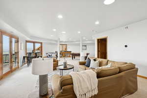 Living area with light colored carpet, pool table, and recessed lighting