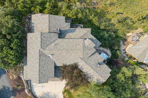 Aerial view of property and surrounding area featuring a heavily wooded area