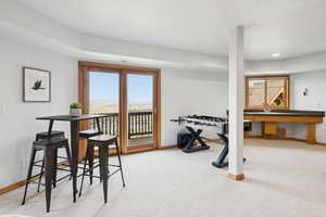 Rec room with carpet and baseboards