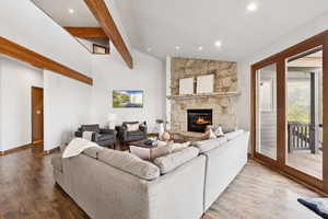 Living area featuring wood finished floors, recessed lighting, and a fireplace