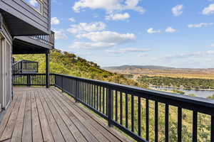 Wooden terrace featuring a water and mountain view