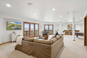 Living area featuring light colored carpet and recessed lighting