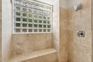 Full bath featuring a tile shower