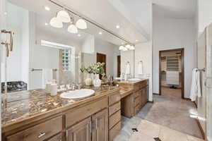 Full bathroom featuring double vanity, a shower, a spacious closet, tile patterned flooring, and recessed lighting