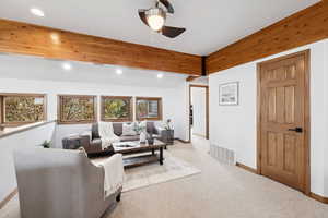 Living room with ceiling fan, recessed lighting, carpet floors, and lofted ceiling