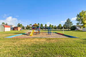 Communal playground with a lawn and an outdoor structure