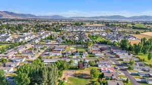 Aerial view of property's location featuring nearby suburban area and a mountainous background