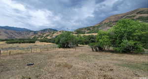 View of mountain backdrop featuring rural landscape