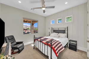 Carpeted bedroom with recessed lighting and a ceiling fan