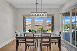Dining area featuring light wood-style flooring and a mountain view