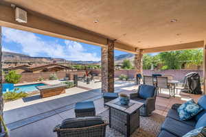Fenced backyard featuring outdoor dining space, a mountain view, a patio area, and outdoor lounge area