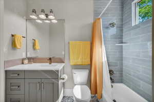 Full bath featuring vanity and shower / tub combo with curtain