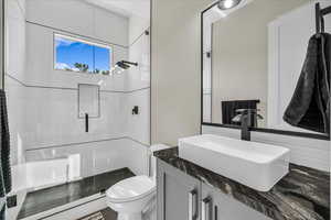 Bathroom with a shower stall and vanity