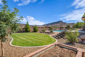 Fenced backyard with a mountain view